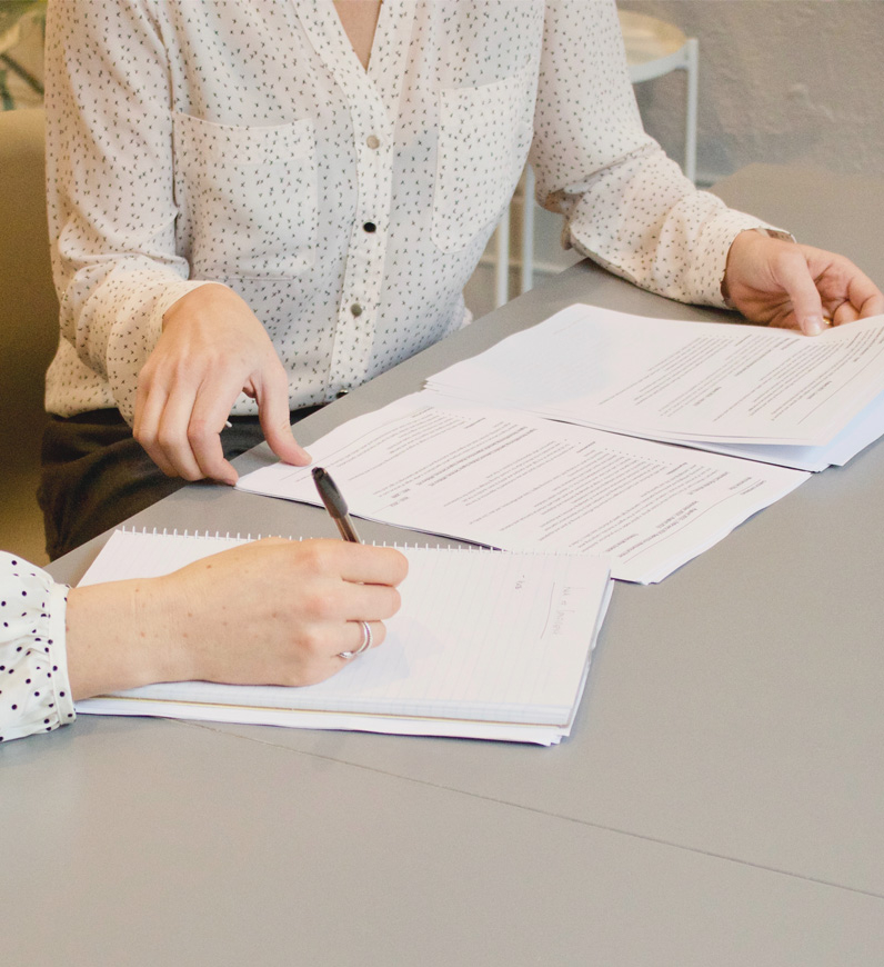 Two women engaged in quality assurance and production service ensuring quality in UX/UI.