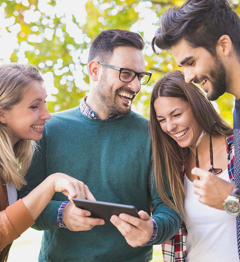 Four people engaged in CX design process, looking at the tablet together, a seamless mapping journey for a satisfying  user experience