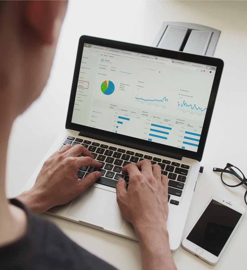 A UX researcher analyzes a graph on a computer screen, utilizing data and analytics to gain insights and stay ahead of competitors.